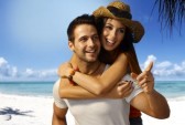 19876117-happy-loving-couple-piggyback-on-tropical-beach-at-summertime-smiling-looking-away.jpg